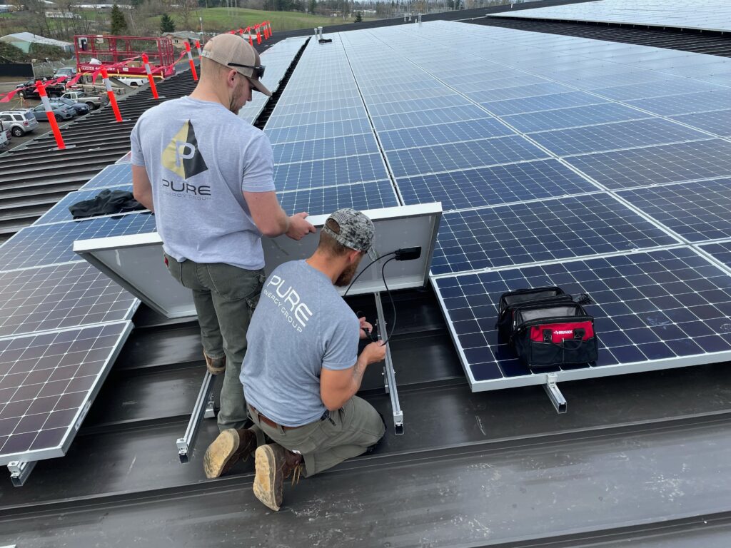 pure energy employees installing solar panels on roof